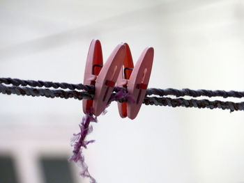 Close-up of rope on bollard against sky