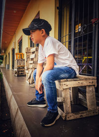 Side view of boy sitting on seat