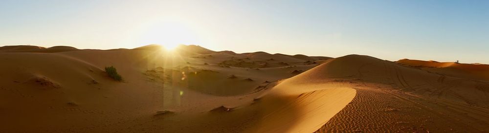 Panoramic view of desert against clear sky