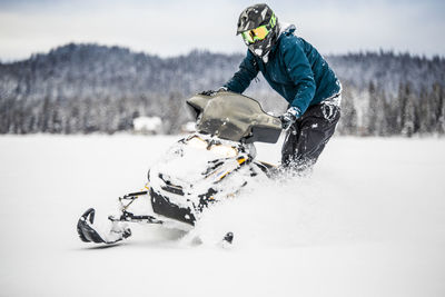 Person riding motorcycle on snow
