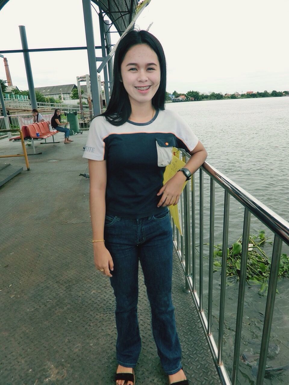 young adult, lifestyles, casual clothing, person, water, looking at camera, portrait, leisure activity, standing, front view, railing, young women, smiling, three quarter length, sitting, sea, sunglasses, happiness