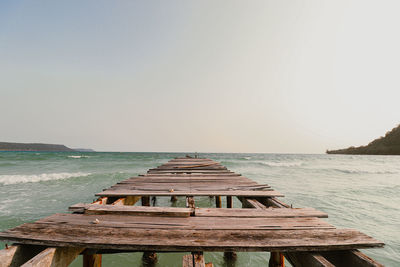 Pier over sea against clear sky