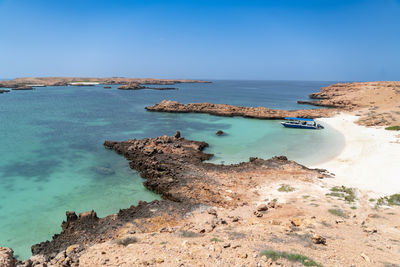 Scenic view of sea against clear blue sky