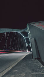 Illuminated bridge in city at night