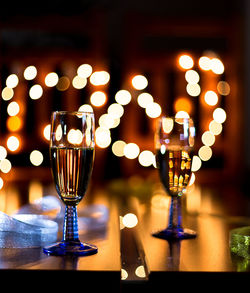 Close-up of wine glass on table at illuminated restaurant
