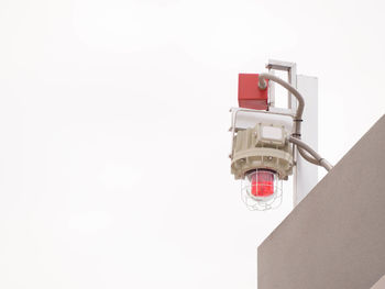 Low angle view of electric lamp against white background