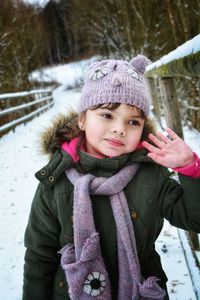 Girl wearing warm clothing looking away during winter