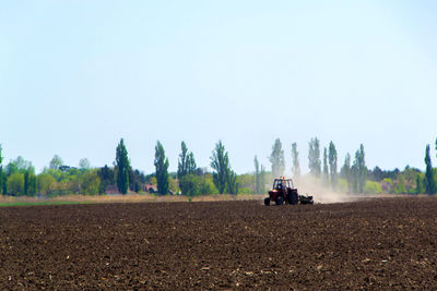 Panoramic view of agricultural field against clear sky