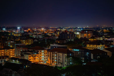 High angle view of illuminated city against sky at night