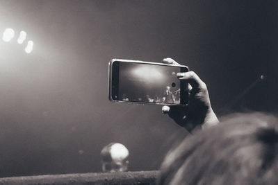 Man photographing with mobile phone