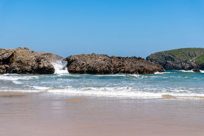 Scenic view of sea against clear blue sky