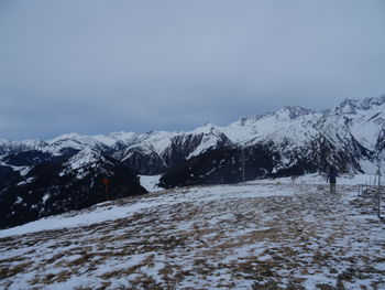 Scenic view of snow covered mountains against sky