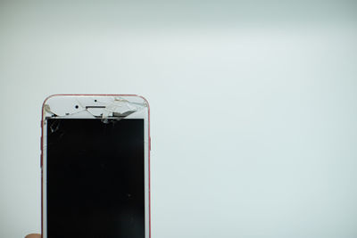 Close-up of telephone pole against white background