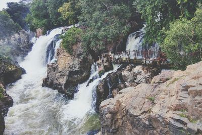 Scenic view of river flowing through rocks