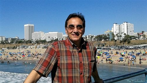 Portrait of smiling man standing against cityscape