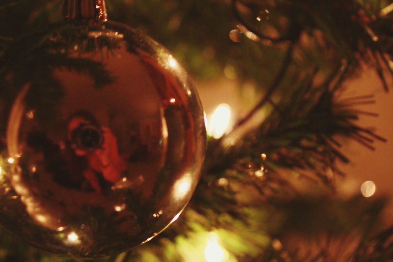 close-up, indoors, illuminated, reflection, transparent, focus on foreground, glass - material, sphere, water, selective focus, christmas, bubble, shiny, celebration, no people, lighting equipment, lens flare, christmas decoration, food and drink, night