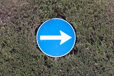 High angle view of road sign on field