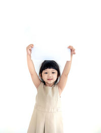 Portrait of girl standing against white background