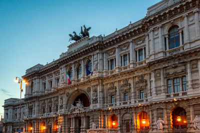 Low angle view of illuminated building against sky