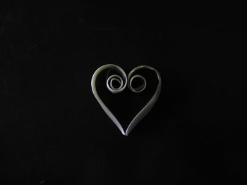 Close-up of heart shape over black background