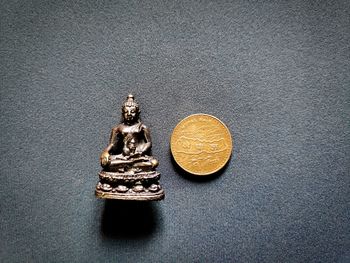 Close-up of coins on table against wall