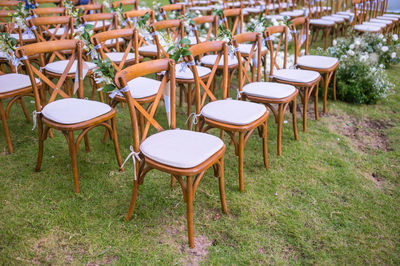 Empty chairs and tables on field