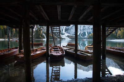 Reflection of wooden pier on lake seen through window