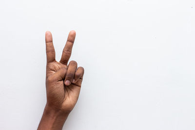 Close-up of human hand against white background