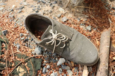 High angle view of old shoes on field
