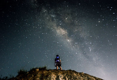 Low angle view of man against sky at night