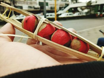 Close-up of hand holding strawberries