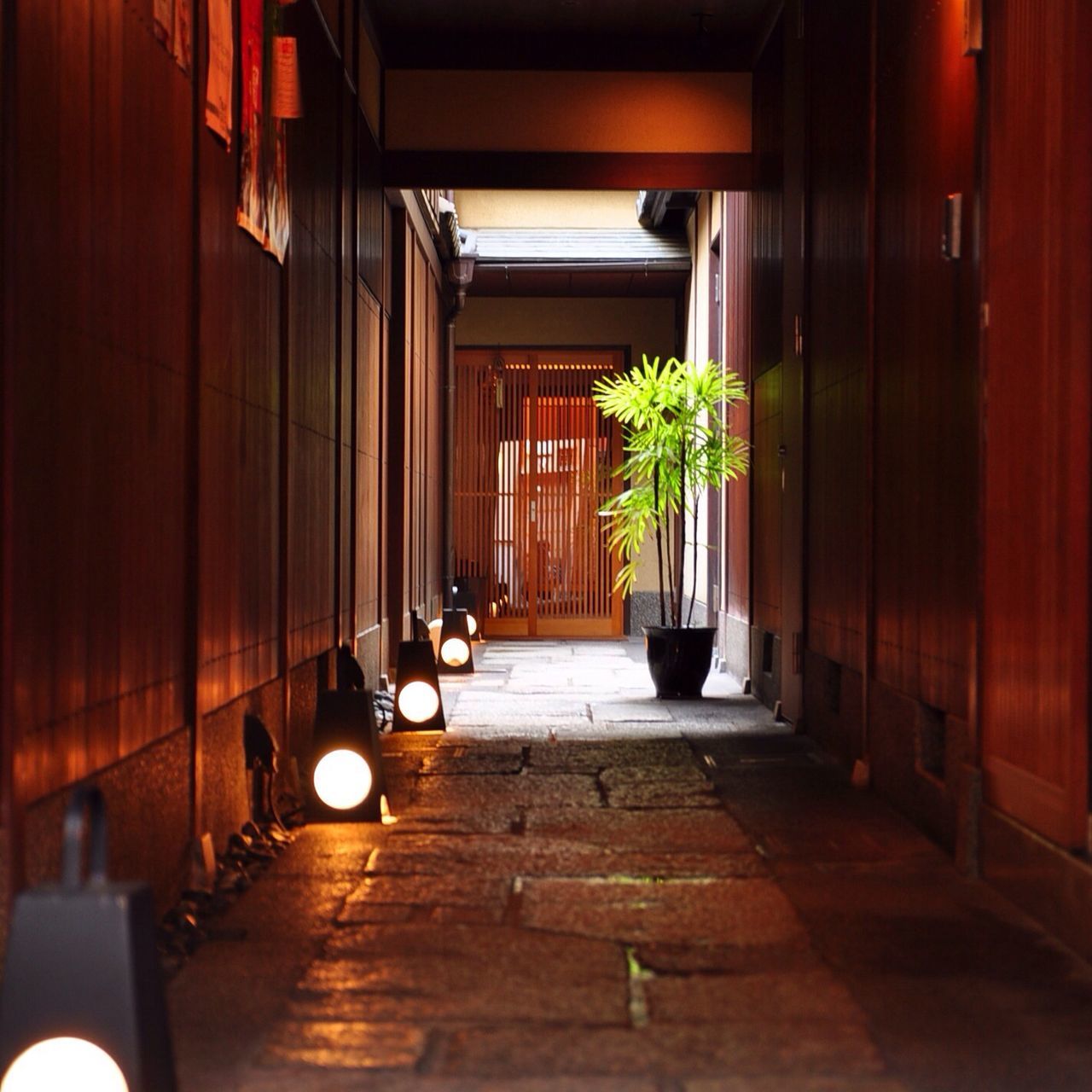 architecture, built structure, the way forward, corridor, indoors, diminishing perspective, building exterior, narrow, illuminated, empty, in a row, building, vanishing point, long, architectural column, walkway, alley, no people, absence, lighting equipment