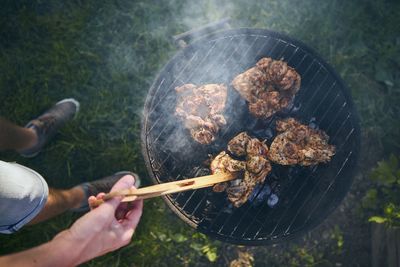 High angle view of meat cooking on barbecue grill