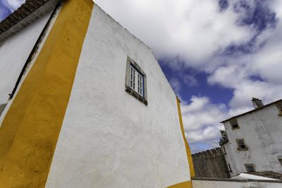 Low angle view of yellow building against sky