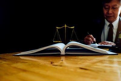 Man reading book on table