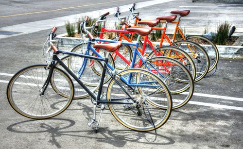 Bicycles parked in row on sidewalk at city