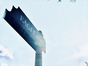 Low angle view of sign against sky