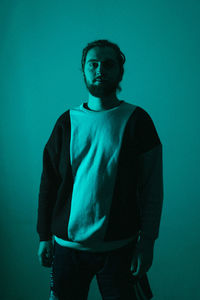 Portrait of a young man against blue background
