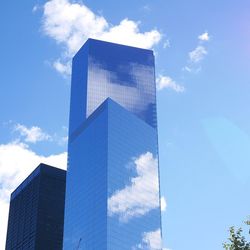 Low angle view of modern building against cloudy sky