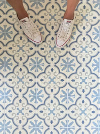 Low section of woman on tiled floor