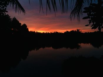 Scenic view of lake against romantic sky at sunset