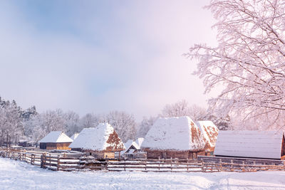 Traditional romanian village in transylvania with old house straw roofing covered with snow 