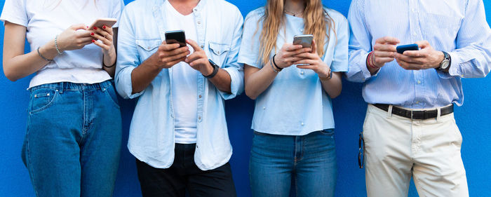 Group of people using mobile phone outdoors