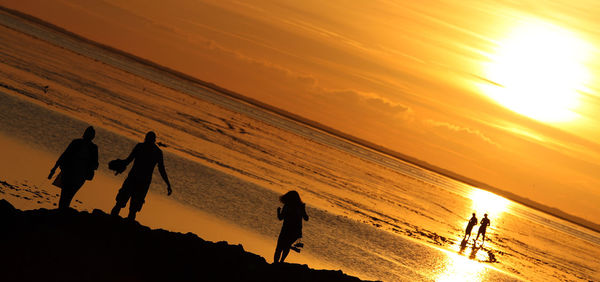 Silhouette of people on beach