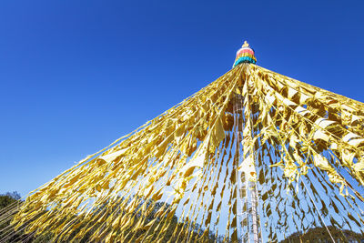 Low angle view of building against clear blue sky