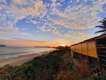 Scenic view of beach against sky during sunset