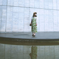 Full length of woman standing by railing