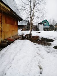 Houses by snow during winter