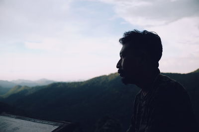 Mature man looking away against mountains