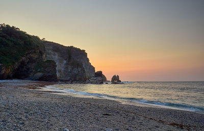 Scenic view of sea against clear sky during sunset